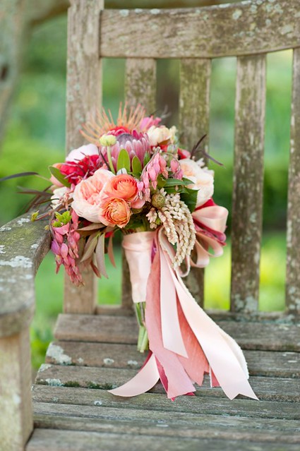 Pink-Peach-and-Purple-Bouquet-With-Ribbons-on-Rustic-Chair-598x900