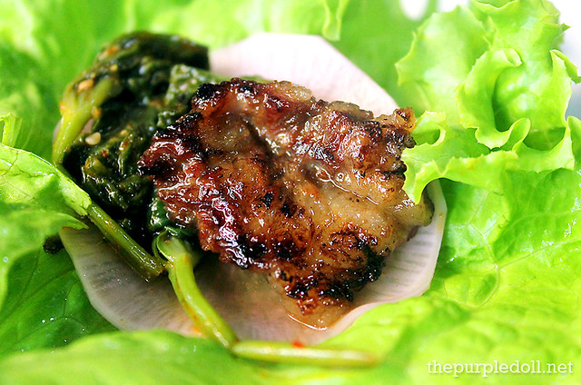 So Galbi wrapped in lettuce with kangkong and pickled radish