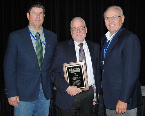 Former NRCS Chief Dave White holding his award from USA Rice Federation, flanked by California rice producers Leo LaGrande (left) and Al Montna (right). Photo: USA Rice Daily (used with permission)