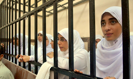 Egyptian women in Alexandria prison cage while being sentenced to 11 years for protesting military rule. The opposition to the generals is increasing. by Pan-African News Wire File Photos