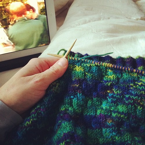 On the couch: working on a knitting project started ages ago while watching what appears to be a cheesy 80's netflix movie #cozyindoors #notgoingoutside