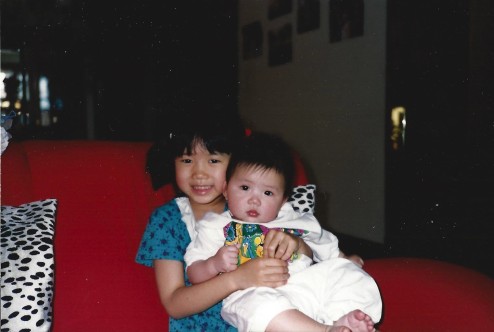 The author as a child holding her sister
