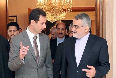 Syrian President Bashar al-Assad with Alaeddin Boroujerdi of the National Security Committee at the Shura Council in the Islamic Republic of Iran. The two Middle Eastern states maintain fraternal relations. by Pan-African News Wire File Photos