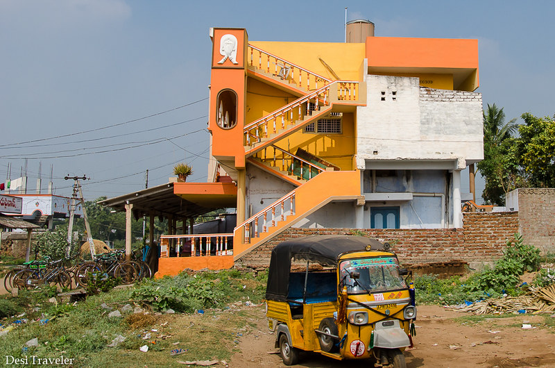 autorickshaw in front of orange house