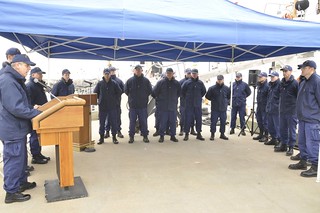 Rear Adm. Daniel Able, commander First Coast Guard District, addresses the crew of the 110-foot patrol boat Bainbridge Island during a ceremony at the cutter’s pier in Bayonne, N.J., March 17, 2014, to bid farewell to the cutter after more than 22 years. During its service the cutter and its crew has conducted many of the Coast Guard’s missions from search and rescue to homeland security. The crew will assume control of the Coast Guard cutter Sitkinak, which was homeported in Miami Beach, Fla. (U.S. Coast Guard photo by Petty Officer 1st Class Gail Dale.)