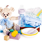 Baby diaper and toys with teddy bear .