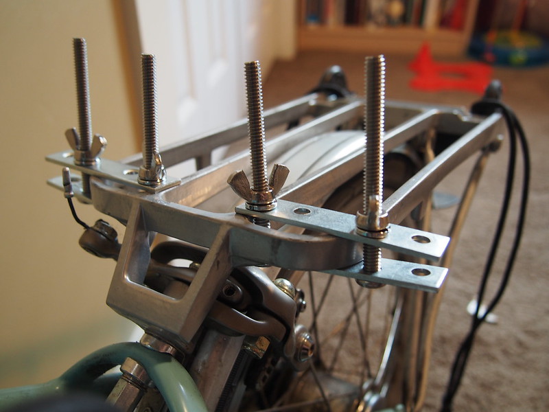Restraining Bolts for Luggage Rack: Similar to the time when I went to the British Isles, I had trouble with my feet hitting the huge bag on the rack.  We devised this solution at the local hardware store.