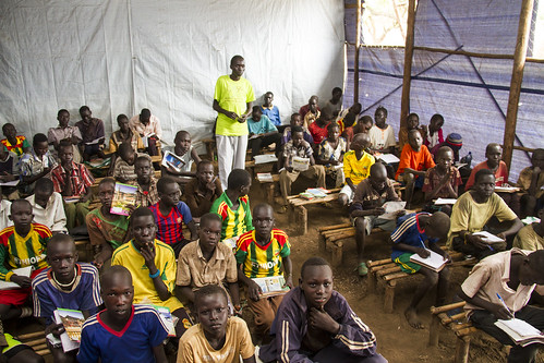 A teacher instructs students in a makeshift classroom