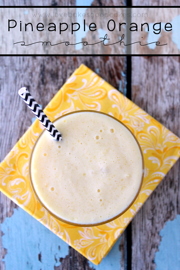 Pineapple Orange Smoothie in a glass with a straw.