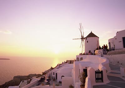 ocean morning travel sea vacation sky people water windmill wall sunrise outdoors coast town europe exterior village painted country greece oia cyclades mediterraneansea thira saltwater hilltown whitewashed southerneurope aegeansea southernaegeanregion