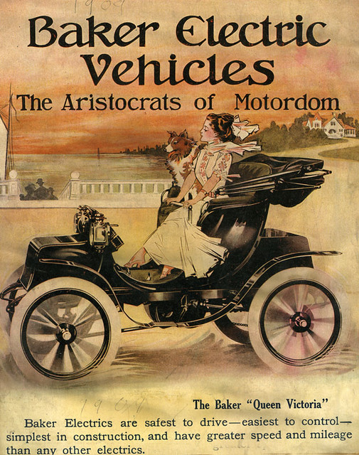 Illustrated ad says "Baker Electric Vehicles: The Aristrocrats of Motordom. Baker Electrics are safest to drive - easiest to control - simplest in construction, and have greater speed and mileage than any other electrics." Illustration shows a young femme person and a dog in an early electric car.