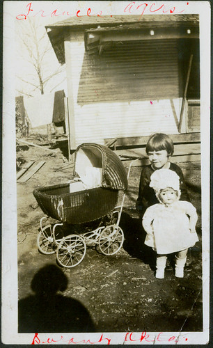 Child with buggy and doll