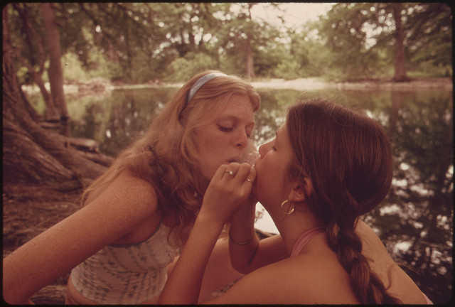 Two Girls Smoking Pot During an Outing in Cedar Woods near Leakey, Texas.