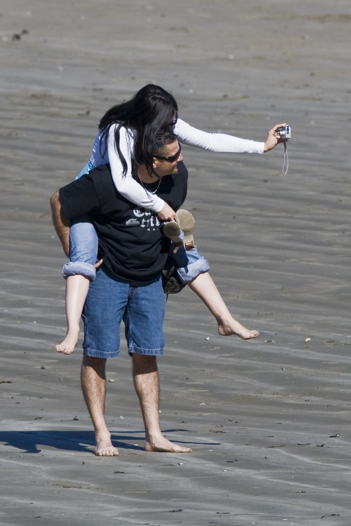 Couple taking their own photo on Morro Strand State Beach couple-take-self-photo