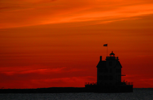 light sunset ohio sky orange sun lighthouse lake water marina lens harbor pier lakeerie flag greatlakes lorain lighthousetrek