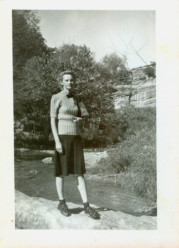 Girl with purse by a stream
