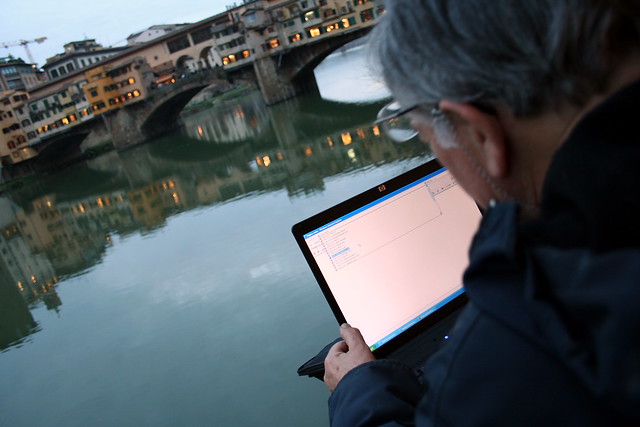 Using hotel Wifi in the street, with view on ponte vecchio