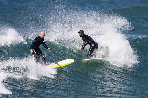 Surfers almost collide at Morro Rock, Morro Bay, CA