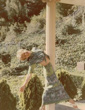 Vera-Ellen swinging on a pillar at home