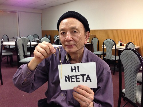 Actor James Hong signing autographs at ComCon in Sacramento. He's holding a chow mein noodle.