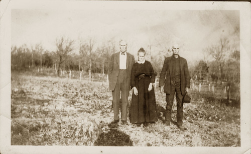 Two men one woman in a field