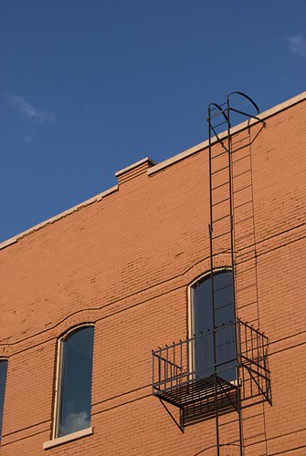 roof red sky orange brick window fireescape ladder