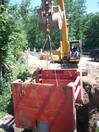 Worker placing a trench box