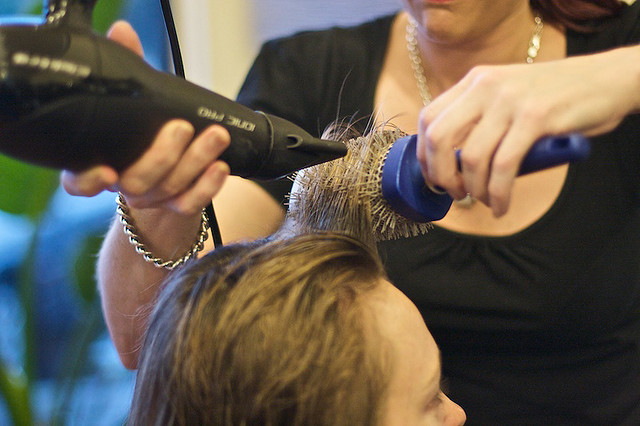 Professional hair stylist curling hair