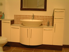 Close up of basin and cupboards