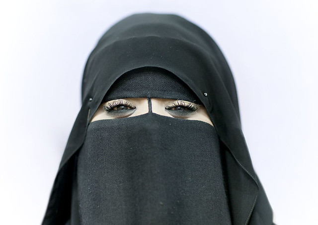 Miss Mouna smiling under her veil, Salalah, Oman