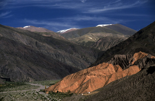 blue red white snow mountains green nature argentina colors beautiful creek river landscape grey rocks colorful stream natural top traditional peaceful hills valley badlands geology northwestern process arid noa humahuaca jujuy sandstones tilcara beuty slopes geomorphology fluvial quebradadehumahuaca semiarid aluvial snowtopped