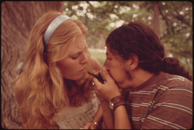 Boy and Girl Smoking Pot During an Outing in Cedar Woods near Leakey, Texas.