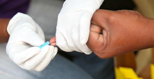 This shows a person having blood drawn from their finger.