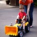 mother pushing son on his toy backhoe    MG 7496
