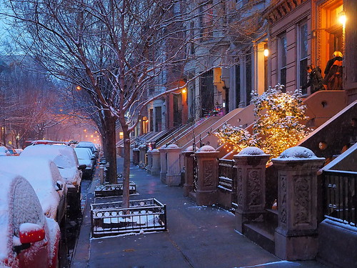 harlem newyork brownstones snow streetscape houses steps peaceful beautiful lights cars urban night street people winter trees