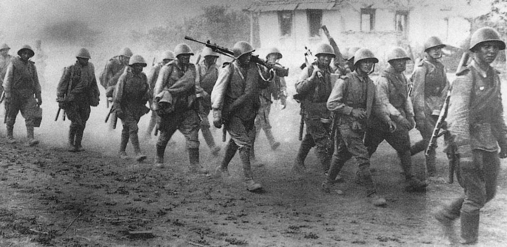 Soviet soldiers of 5th Guards Army marching through a village near Prokhorovka, south of Kursk, during the Battle of Kursk. July 1943.