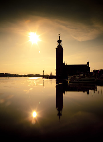 sunset sun reflection water ferry reflections mirror boat sweden stockholm cityhall riddarfjärden stadshuset