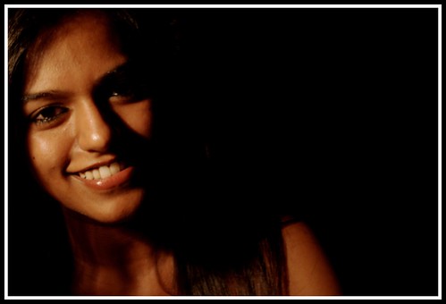 nikon d60 dslr nikond60 10 megapixel vr eopath india portrait girl ladp smile happy photography indian dusky hair eyes human lamp posing fashion light dark sepia features nice beautiful woman photo pic picture frame wall calm lighting face glow