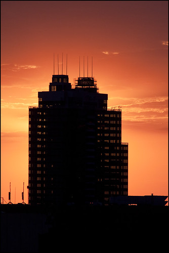 orange tower silhouette sunrise construction downtown edmonton alberta epcor isitjustmeordooneofthespireslookcrooked
