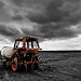 Tractor under a dark cloud