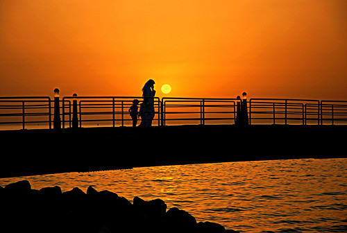 sunset sea orange sun man black beach water sunshine kids walking gold lights golden pier nikon silhouettes kuwait kuwaitcity souqsharq d300 theunforgettablepictures saadalenzi