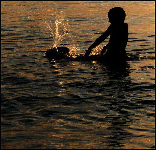 boy sunset shadow lake beach water michigan frisbee splash