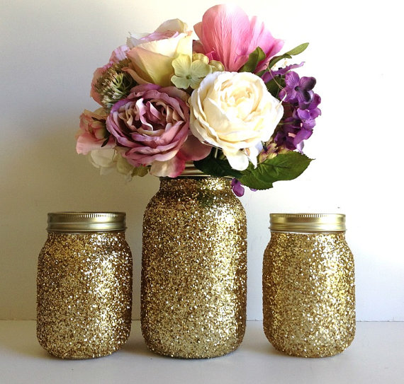 mason jars turned into flower vases and covered with gold sparkles 