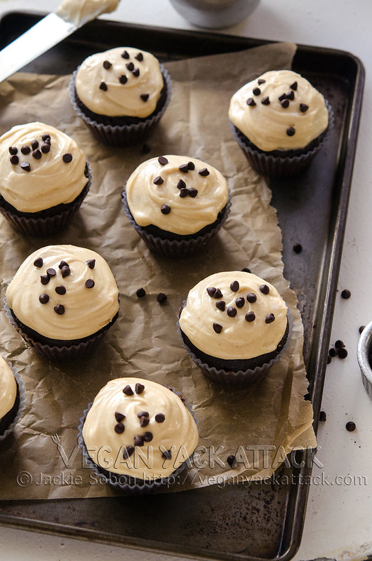Chocolate cupcakes on a baking sheet lined with parchment paper
