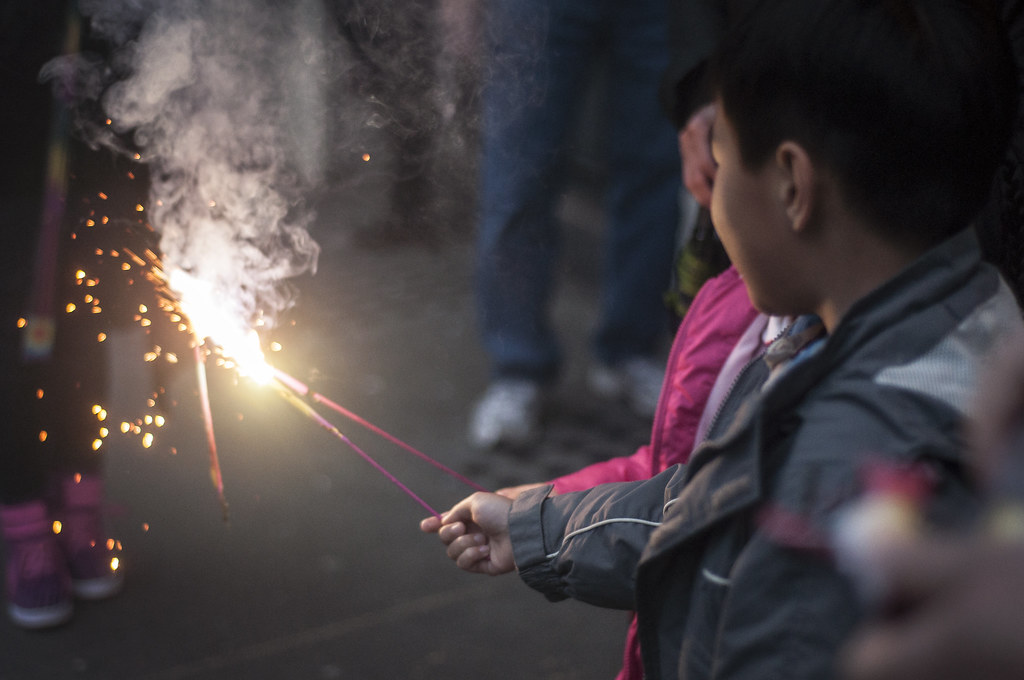 Children light sparklers and other fireworks on Clay Street during San Francisco's Chinese New Year Parade Saturday, Feb. 15. Photo by Jessica Christian / Xpress