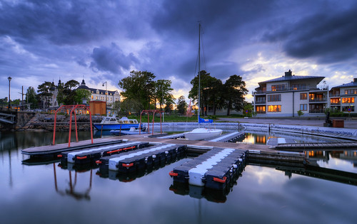 bridge trees houses sunset signs grass night clouds reflections boats restaurant sailing cloudy sweden stockholm dusk cab taxi pipe balconies boardwalk sverige lamps mast ropes railing cicero hdr grandhotel waterscape saltsjöbaden nacka