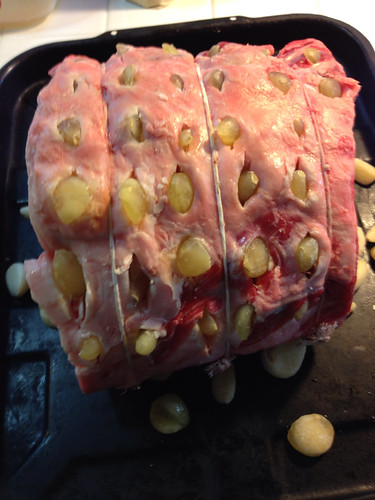 Prime rib studded with garlic cloves, ready for roasting