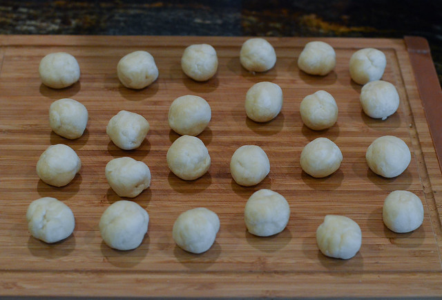 Small balls of dough on a cutting board.