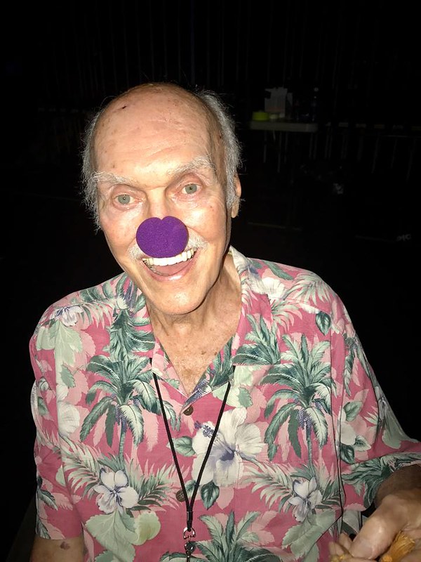 Seva co-founder Ram Dass gets silly with a purple clown nose.