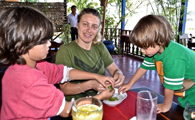 a mother and two kids cleaning up after eating in la danta restaurant, flores restaurant
